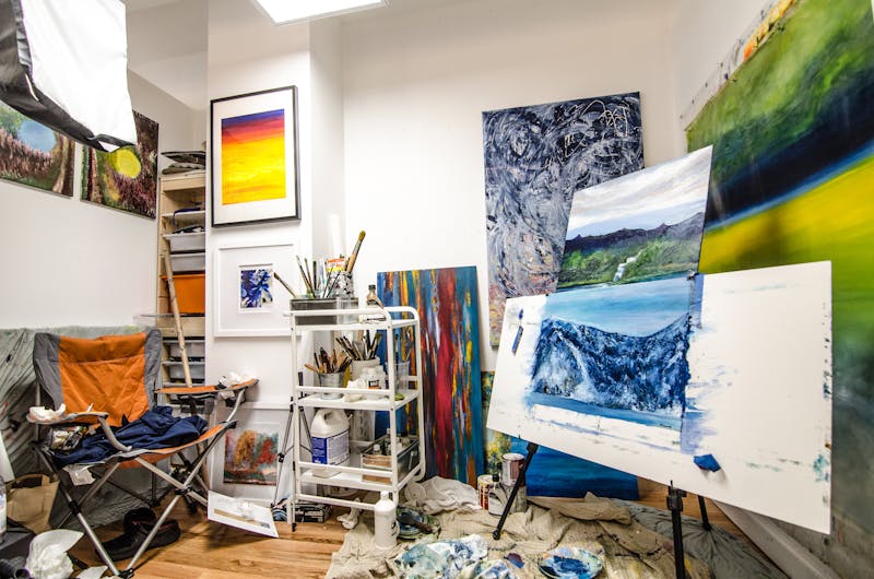 Colorful artist's studio with paints and brushes, creative cannabis strain effect for ideation