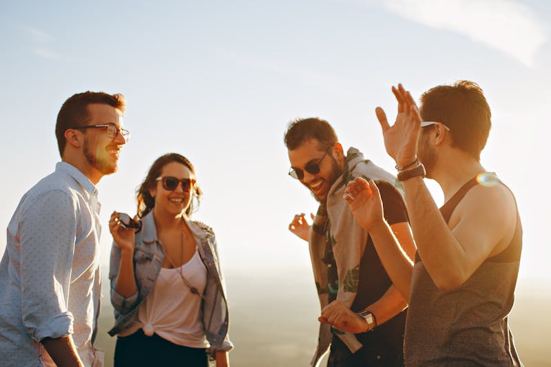 Friends enjoying outdoor sunshine, energetic sativa cannabis strain effect for daytime activity