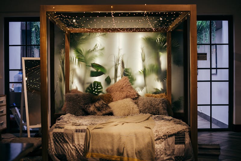 Cozy bed with warm lamp light, sleepy indica cannabis strain effect for nighttime wind-down